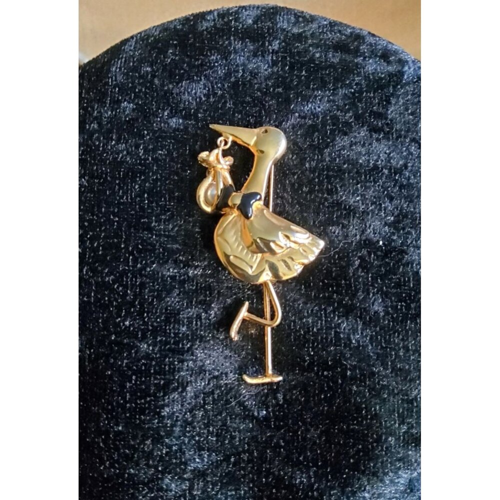 vintage gold tone/black bowtie stork with faux pearl dangling baby bundle brooch